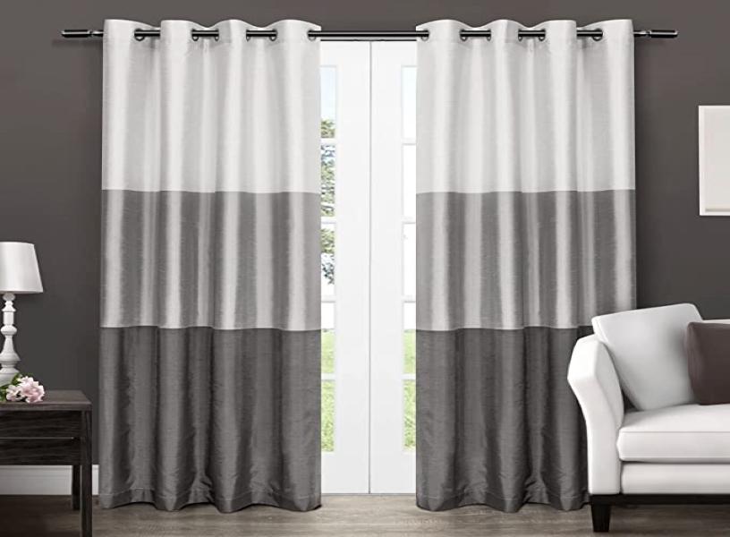 The rich silk curtains in a chateau feature a wide horizontal stripe pattern.