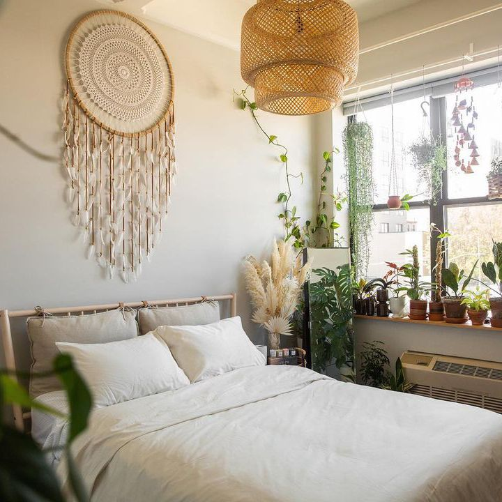 Boho bedroom ideas by using patterned area rugs, throw blankets, or pillows